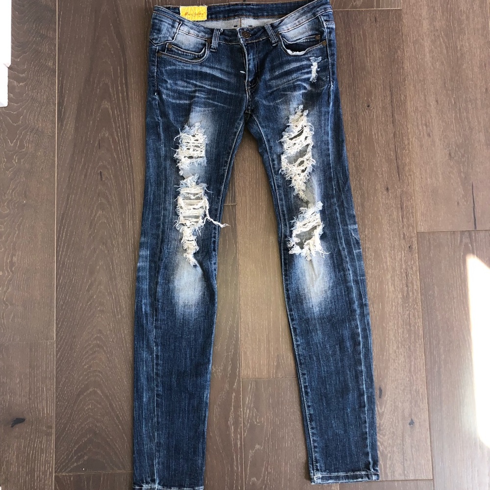 Machine distressed low rise skinny jean